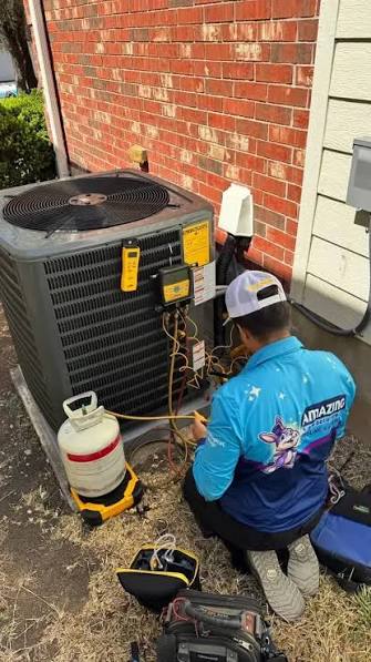 HVAC technician checking connections on an outdoor air conditioning system